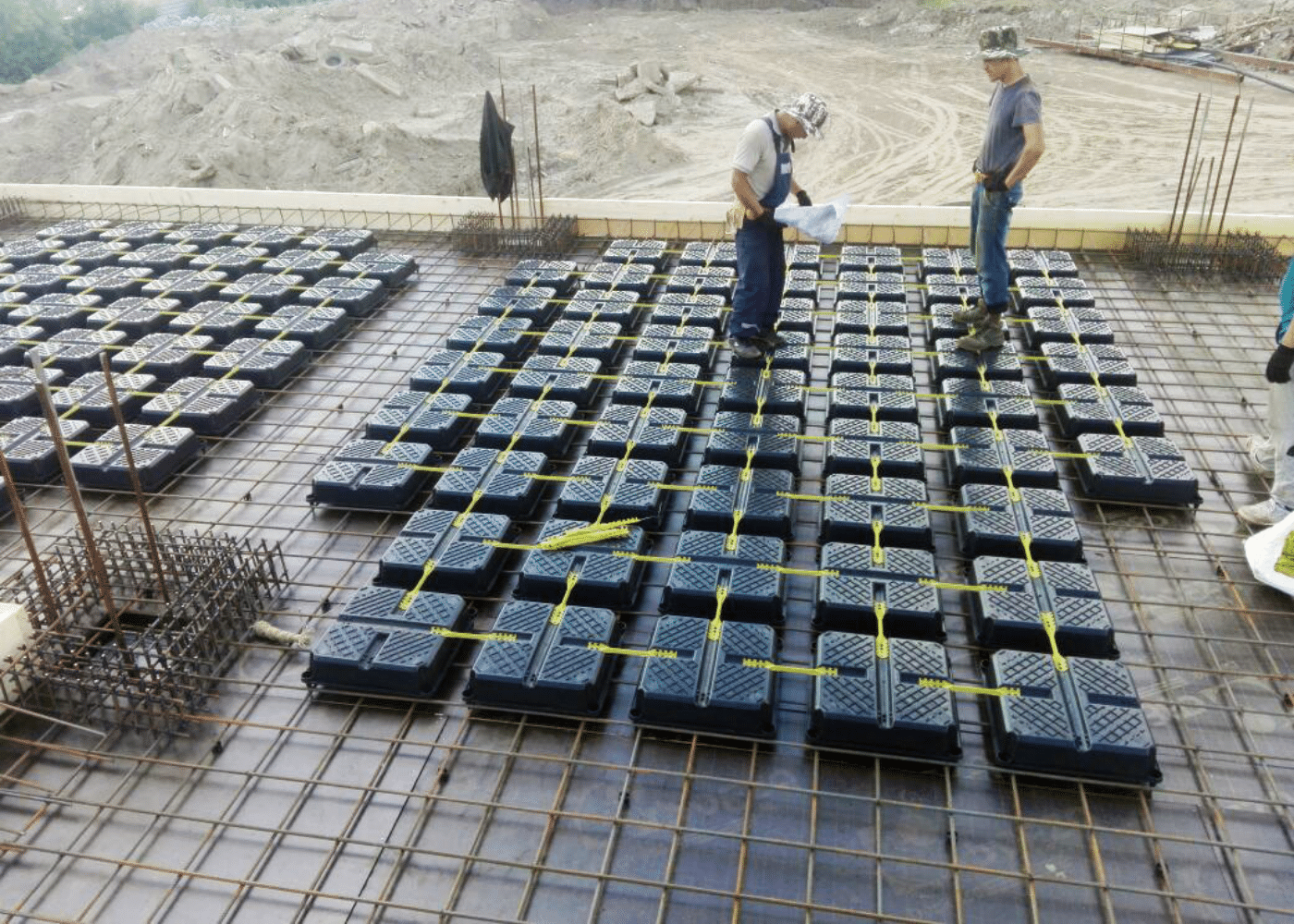 Image showcasing the compressible fill, expanded polystyrene void formers being installed in a concrete foundation with square edges