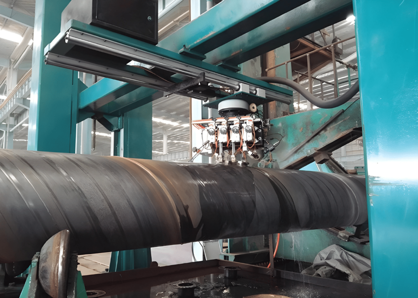 Automated spiral welding machine creating spiral welded steel pipes for infrastructure and offshore use.